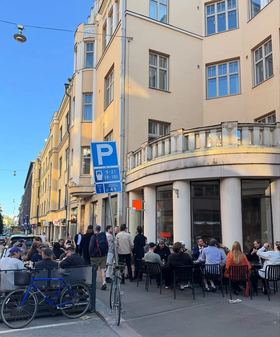 Gente en la calle ante el pop-up de Helsinki, un día de sol.